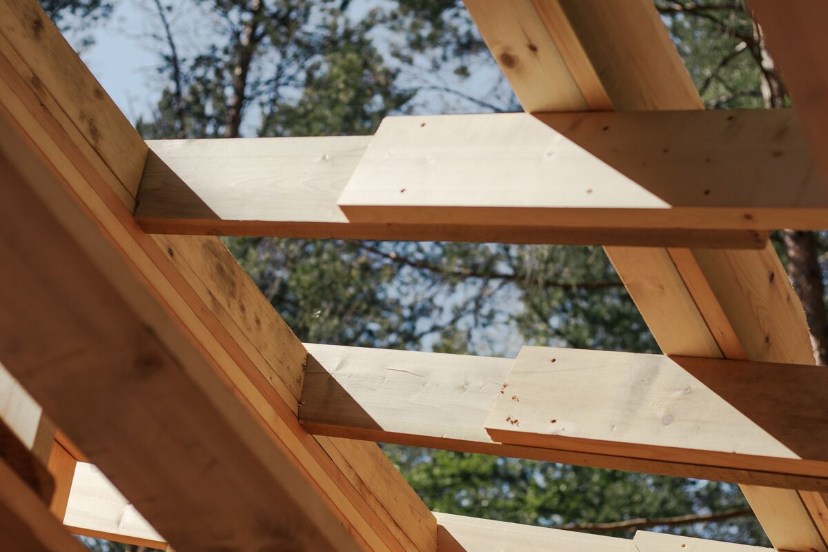 House framing walls under construction in sunlight, with diagonal bracing